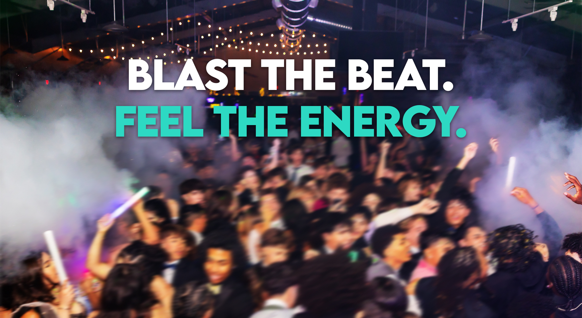 CO₂ blasters shooting powerful white plumes over a packed dance floor during a live event