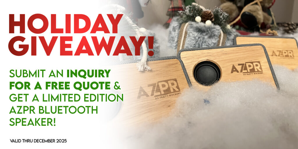 Holiday giveaway Bluetooth speaker with engraved AZPR logo displayed as part of Arizona Premier Rentals seasonal promotion.